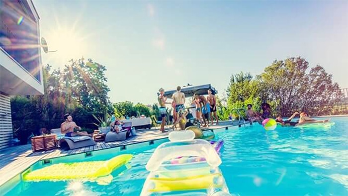 Group of people around a swimming pool