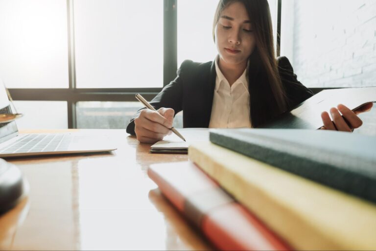 Female tort lawyer going over paperwork