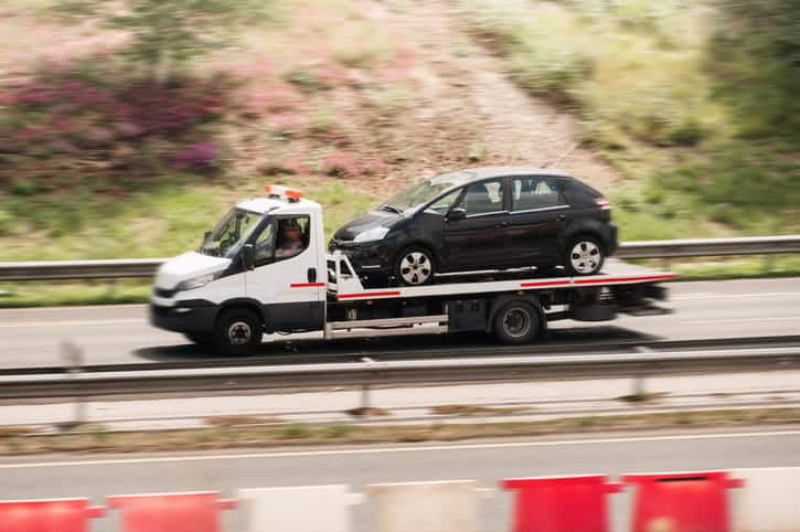 A leased vehicle being towed after a car accident.