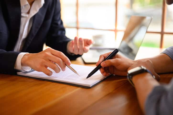 A lawyer reviewing a settlement agreement with her client.