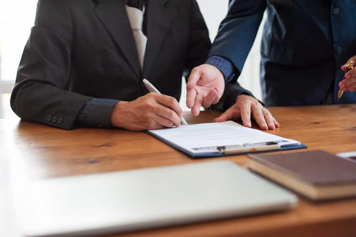 Two personal injury attorneys reviewing paperwork for a case.