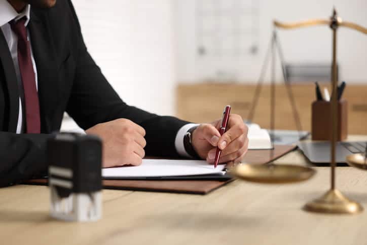 A lawyer working on paperwork at his desk.