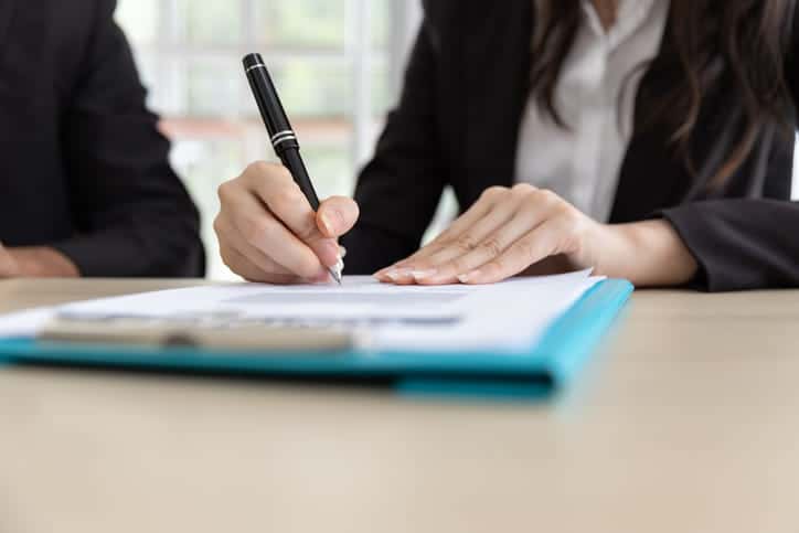 A personal injury attorney works on paperwork for a client.