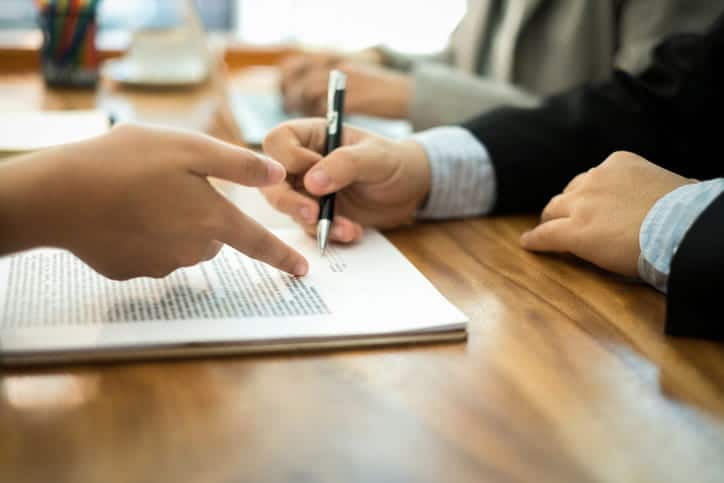 A personal injury attorney reviews paperwork with a client.