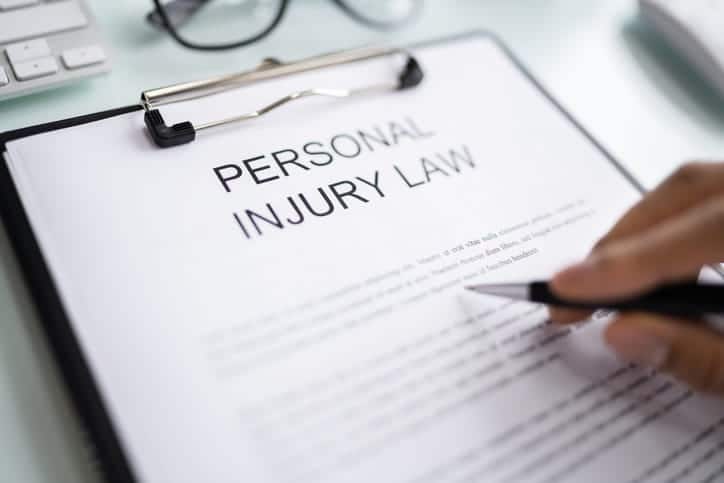 A clipboard with a form reading "personal injury law. "